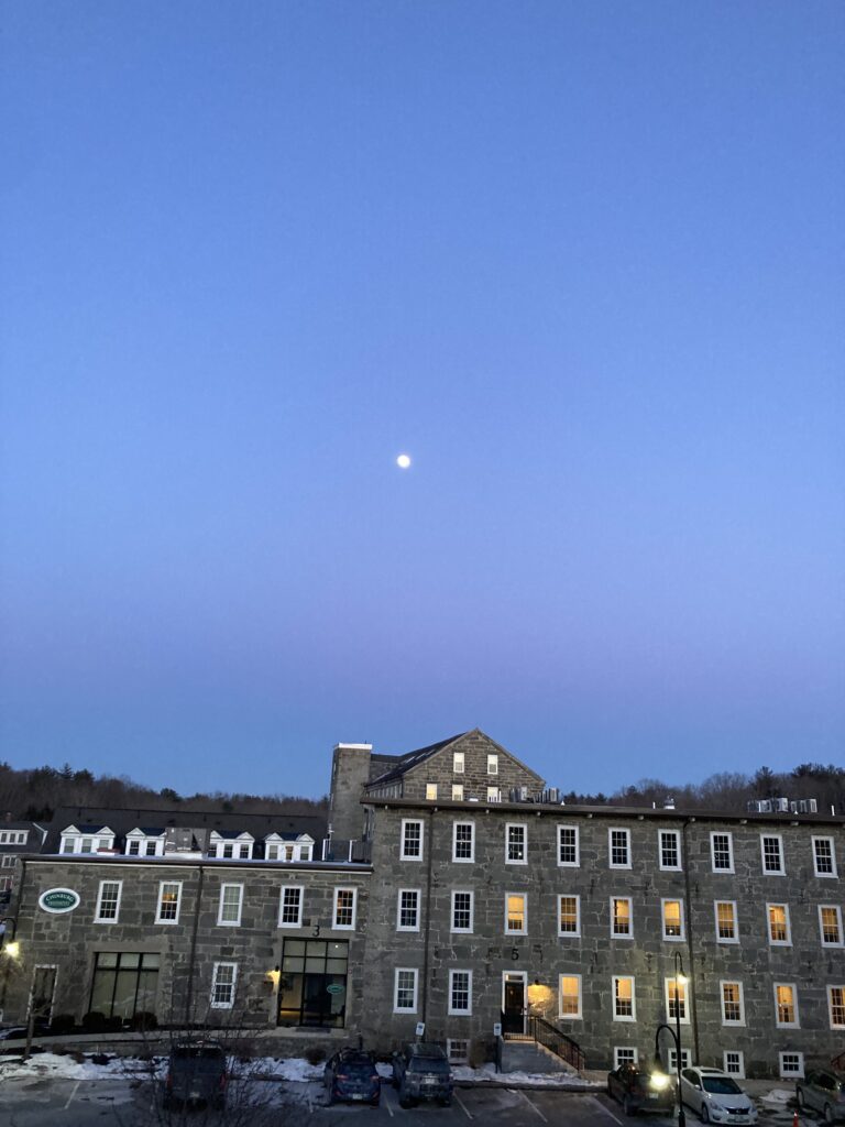 Moon over mill buildings in a small New Hampshire town.